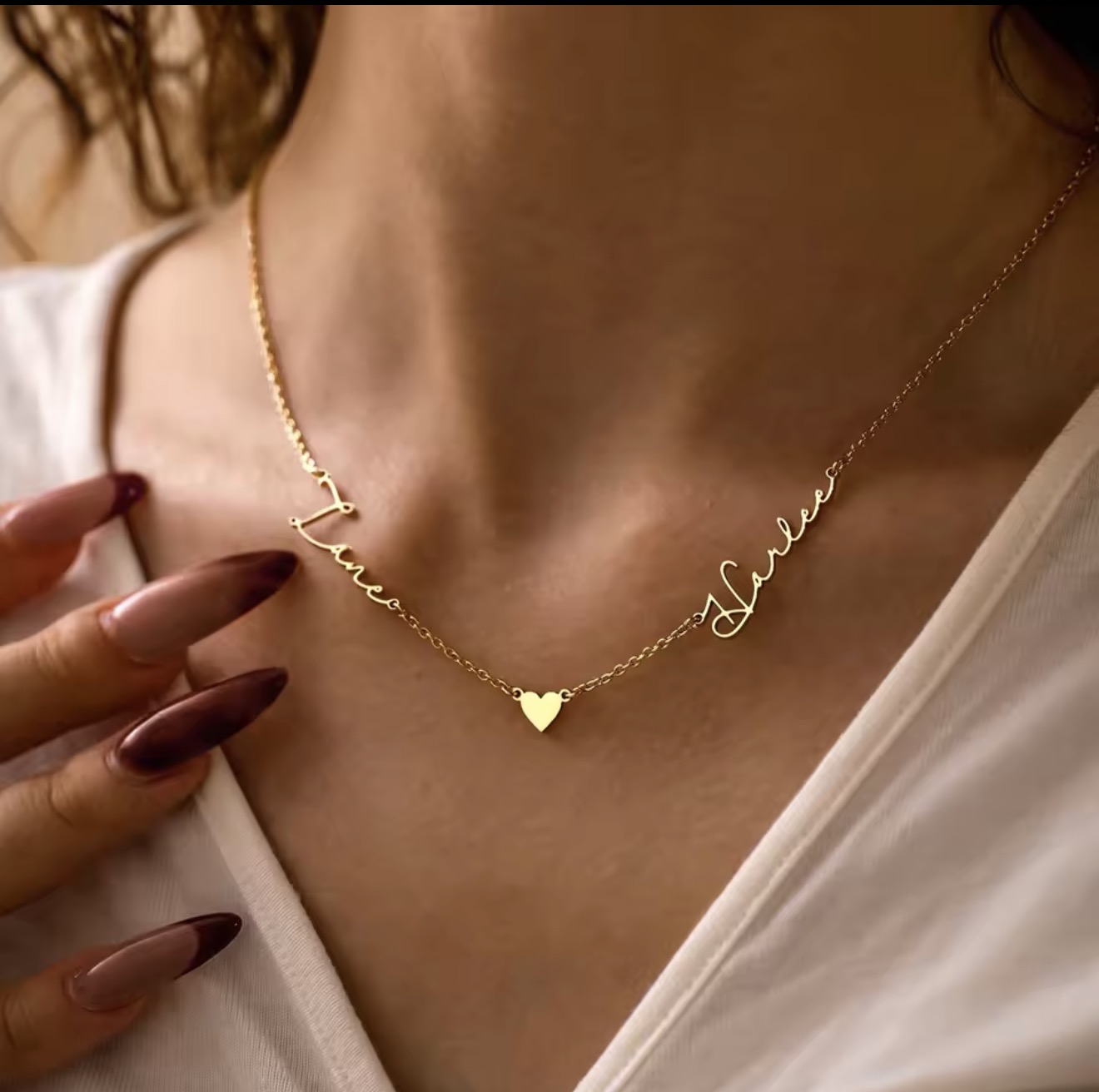 Gold necklace with two names and a heart